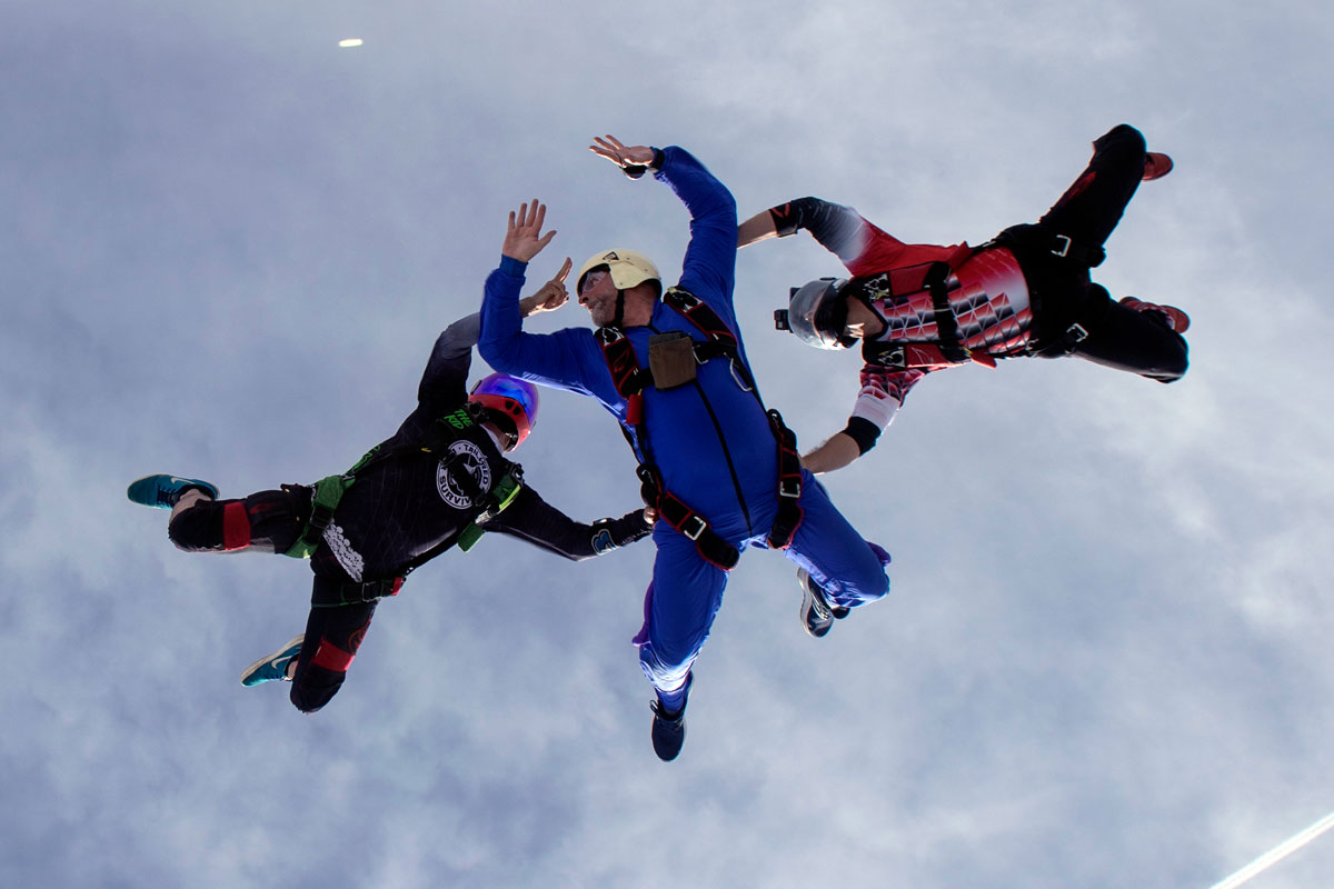 Male in blue skydiving gear participating in AFF training at Skydive City