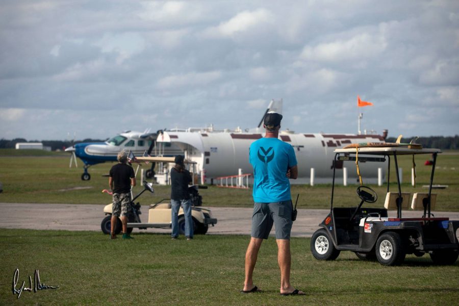 Skydiving observers watching above.