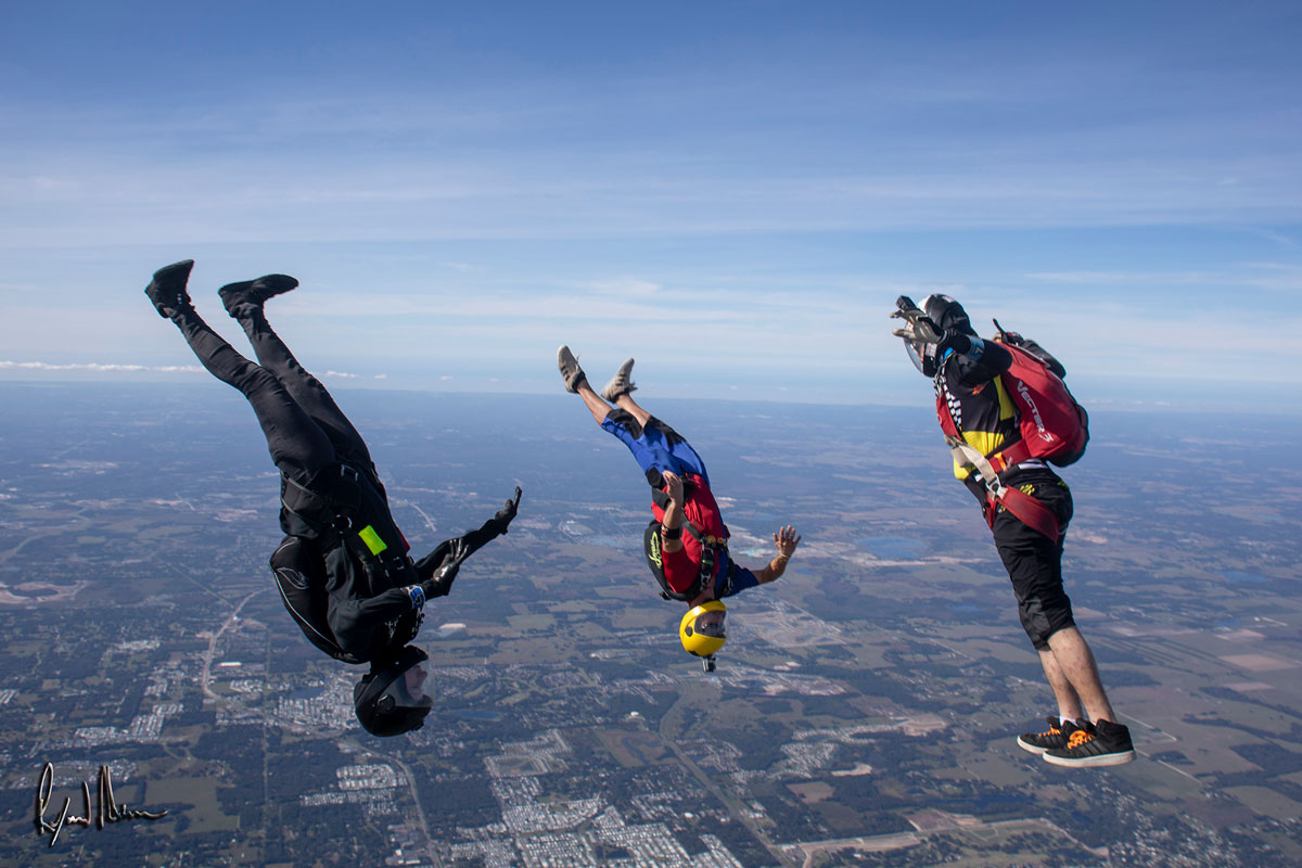 Experienced skydivers in free fall head down.