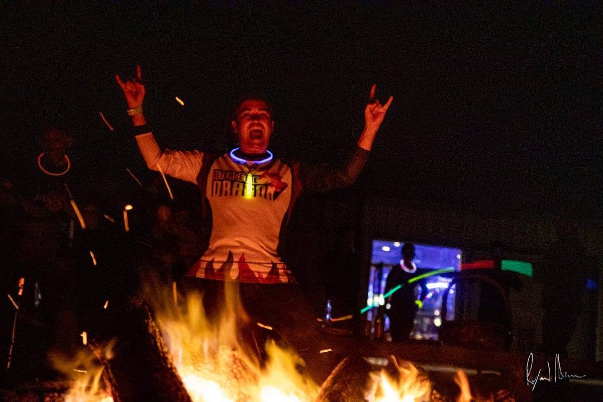 Man enjoying fire pit at Skydive City Z-Hills
