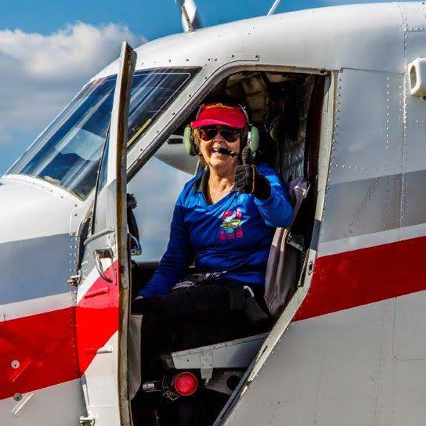 Sandy Carruth giving thumbs up in Skydive City aircraft.