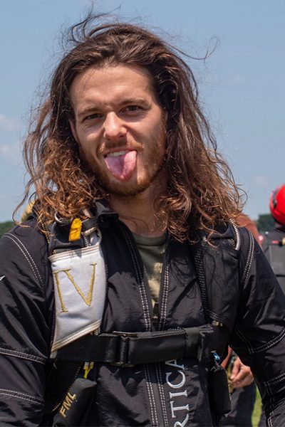 David Lang sticking tongue out after landing from a skydive