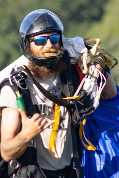 Dereck Dittman walking with skydiving canopy.