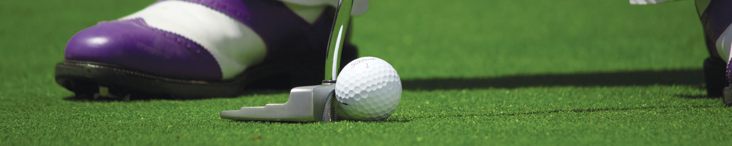 Purple and white golfing shoes and ball.