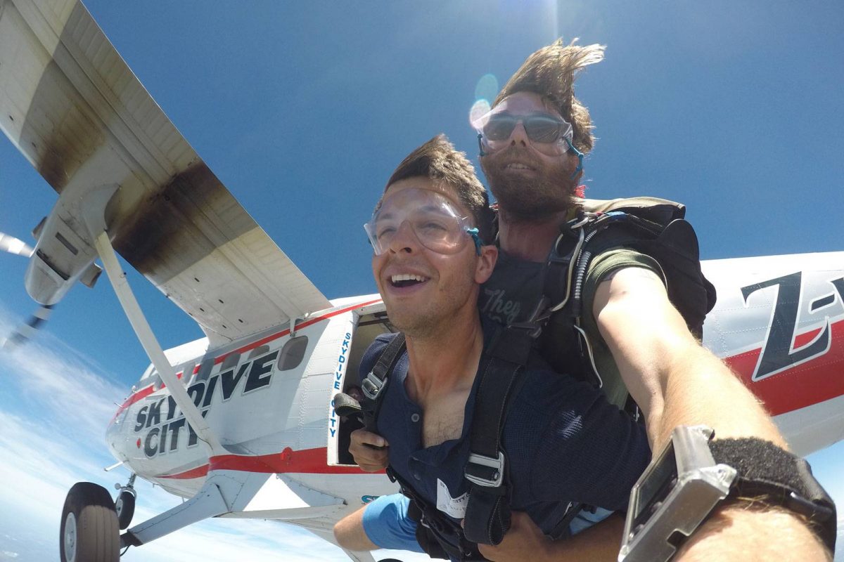 Male tandem skydiver in freefall after jumping from Skydive City aircraft.