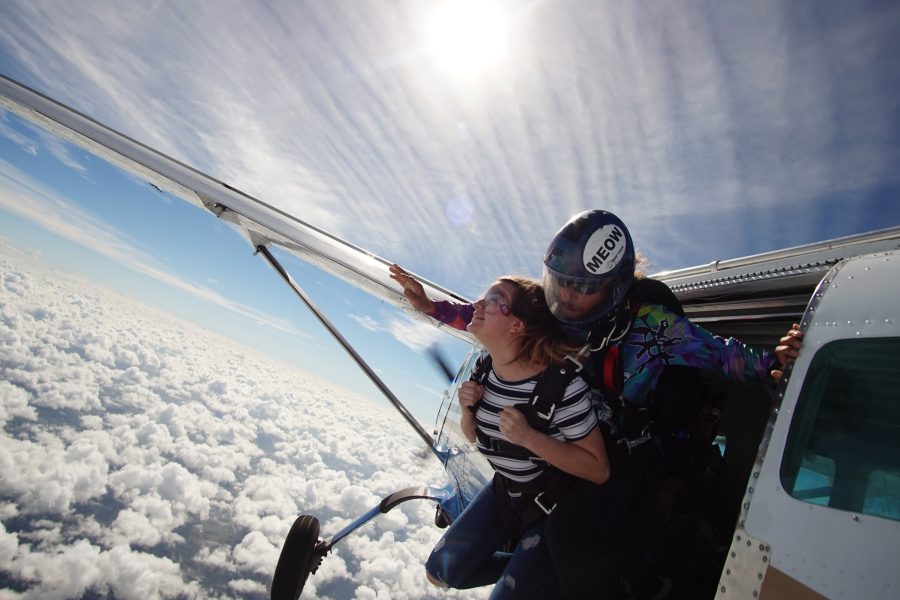 Female tandem skydiver about to take the leap from a plane at Skydive City