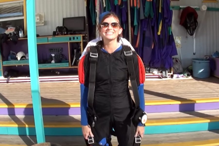Female tandem jumping suiting up before skydive at Skydive City.