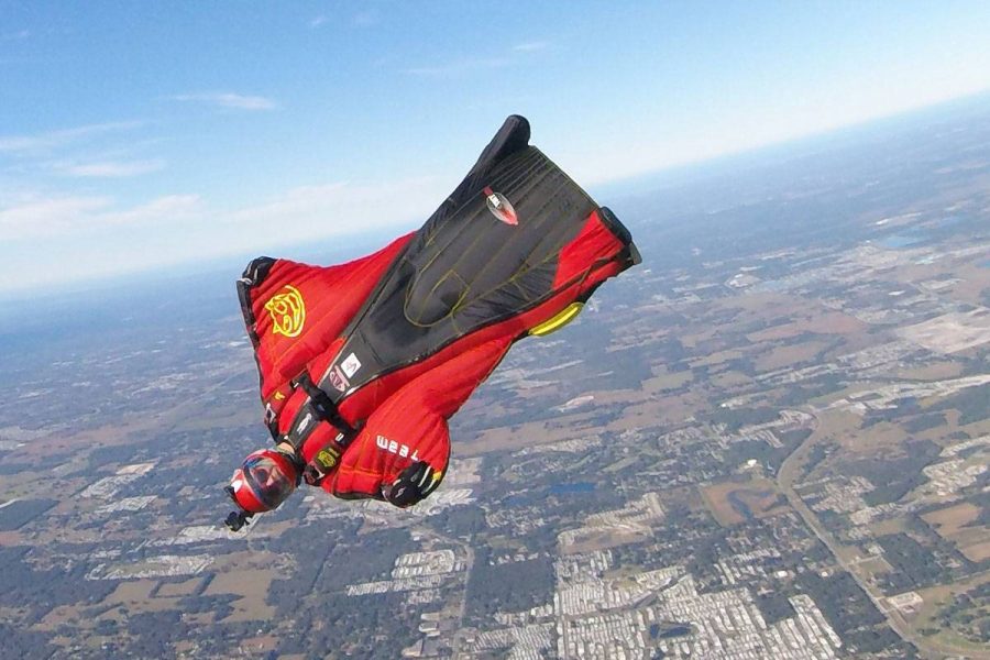 Travis Mickle wearing a red and black wingsuit