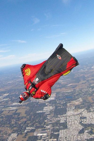 Travis Mickle wearing a red and black wingsuit